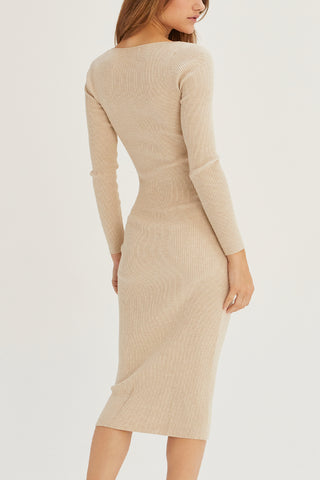 A model wearing an oatmeal sweater dress.