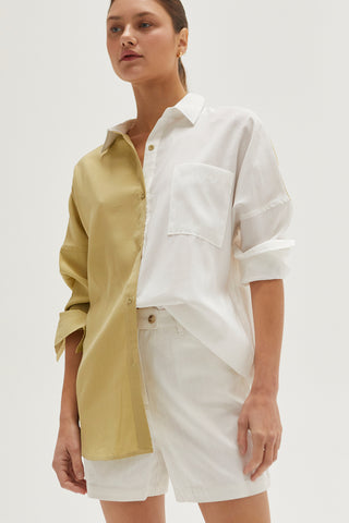 A woman wearing an ivory high rise shorts.