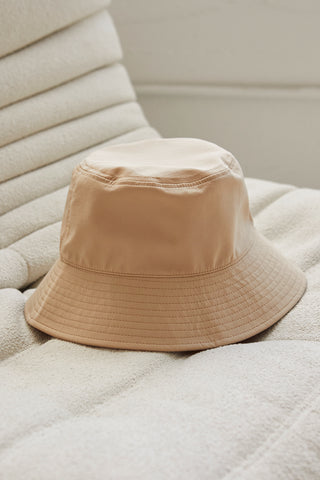 A beige parachute bucket hat.