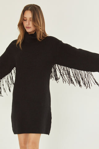 A model wearing a black sweater dress.