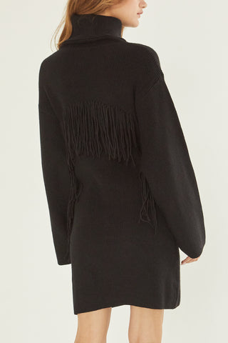 A model wearing a black sweater dress.