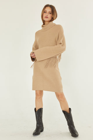 A model wearing a tan sweater dress.