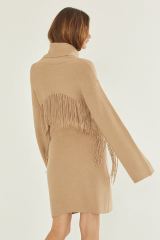 A model wearing a tan sweater dress.