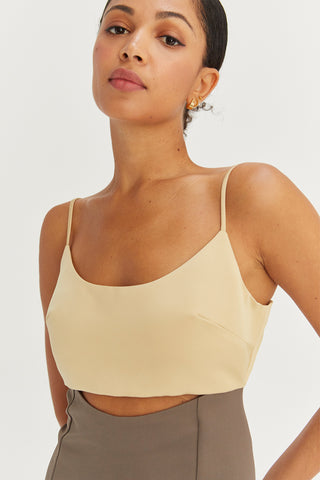 A model wearing a yellow/grey color-block satin midi dress.