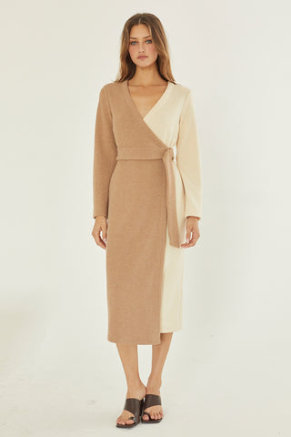 A model wearing a taupe/cream color-block knit dress.