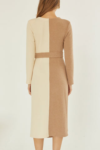 A model wearing a taupe/cream color-block knit dress.