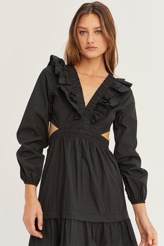 A woman wearing a black tiered poplin maxi dress with back cut out details.
