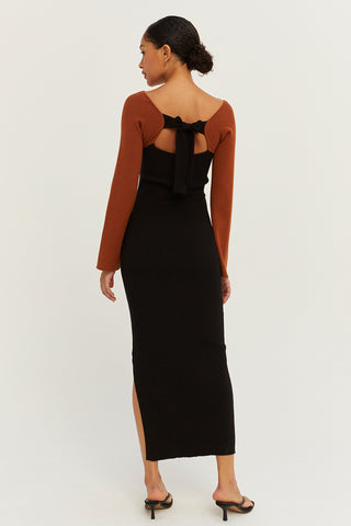 A model wearing a cognac/black color block knit midi dress.