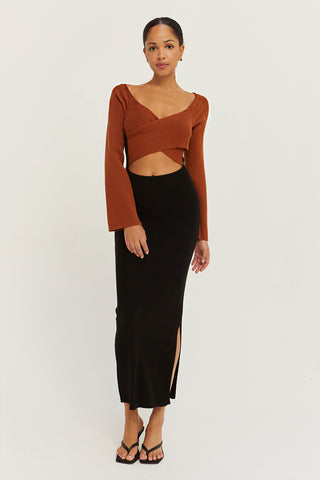 A model wearing a cognac/black color block knit midi dress.