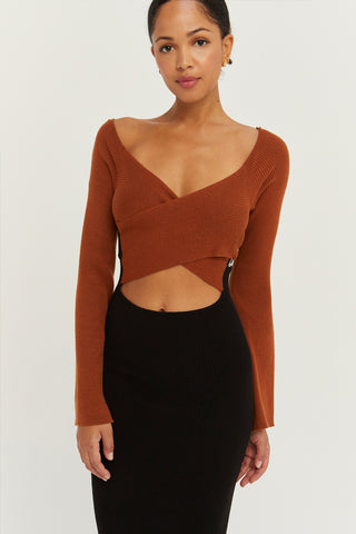 A model wearing a cognac/black color block knit midi dress.