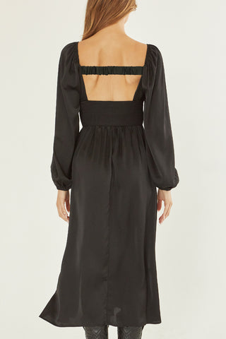 A model wearing a black satin midi dress.