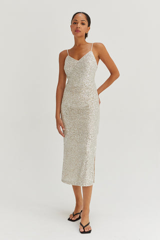 A model wearing a silver sequins tie back midi dress.