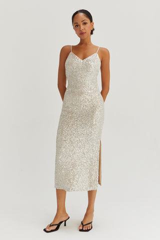 A model wearing a silver sequins tie back midi dress.