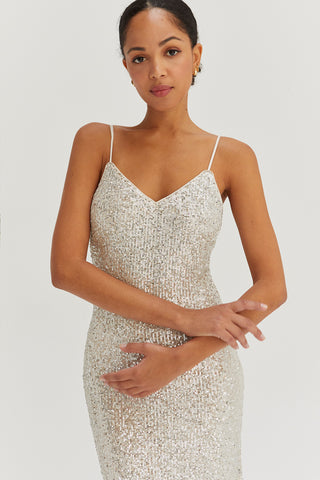 A model wearing a silver sequins tie back midi dress.