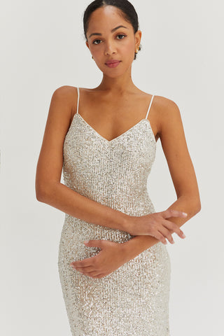 A model wearing a silver sequins tie back midi dress.