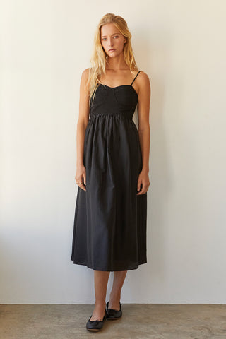 A model wearing a black bustier texture play maxi dress.