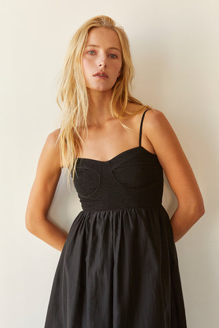 A model wearing a black bustier texture play maxi dress.