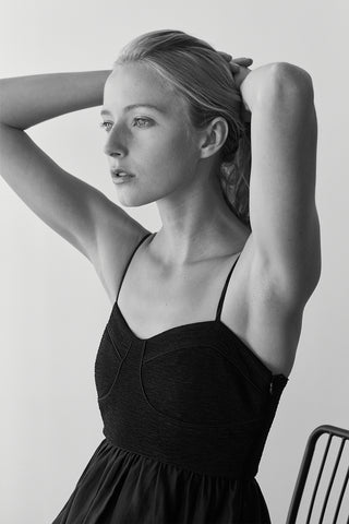 A model wearing a black bustier texture play maxi dress.