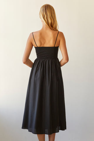 A model wearing a black bustier texture play maxi dress.