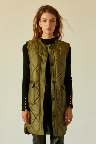 A model wearing an olive quilted puffer vest.
