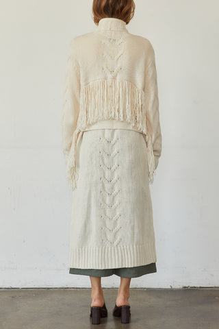 A model wearing a cream fringe duster cardigan.