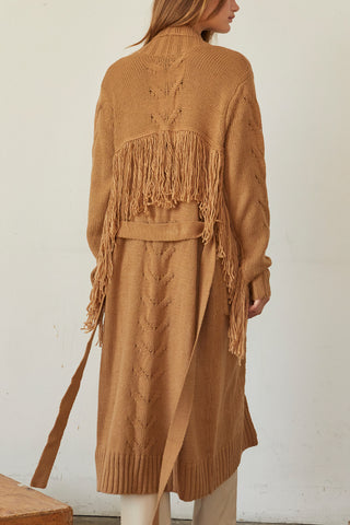 A model wearing a camel fringe duster cardigan.