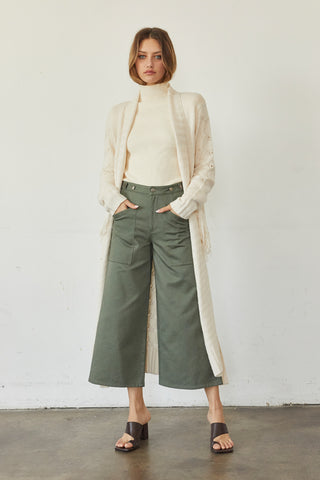 A model wearing a cream fringe duster cardigan.