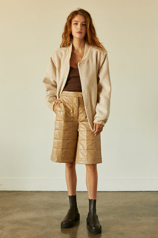 A model wearing a bone brushed vegan wool bomber jacket.