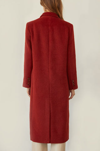 A model wearing a brick brushed vegan wool coat.