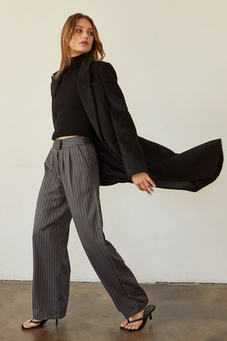 A model wearing a black brushed vegan wool coat.
