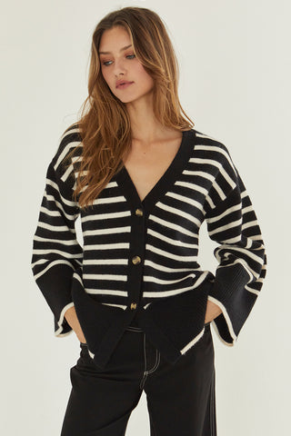 A model wearing a black stipe cardigan.