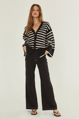 A model wearing a black stipe cardigan.