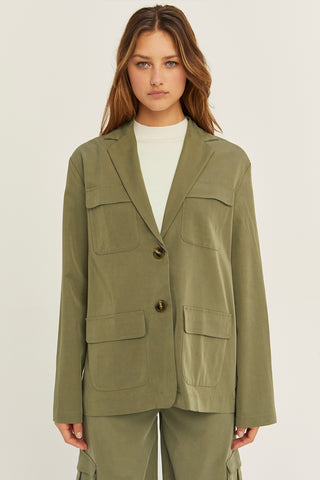 A woman wearing an olive Tencel utility blazer with matching pants.