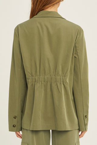 A woman wearing an olive Tencel utility blazer with matching pants.