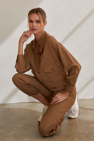 A model wearing a brown lightweight rayon-Tencel blend jacket with matching pants.