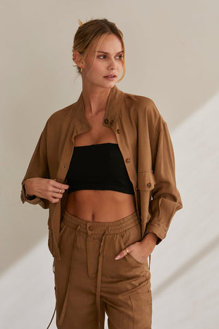 A model wearing a brown lightweight rayon-Tencel blend jacket with matching pants.