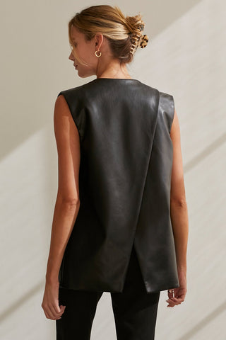 A model wearing a black vegan leather vest.