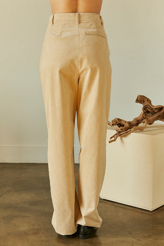 A woman wearing a beige corduroy trousers.