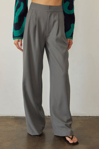 A model wearing a cool grey wide-leg trousers.