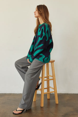 A model wearing a cool grey wide-leg trousers.
