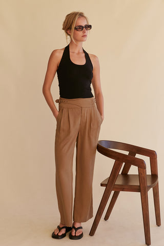 A model wearing a khaki wide leg Tencel trousers.