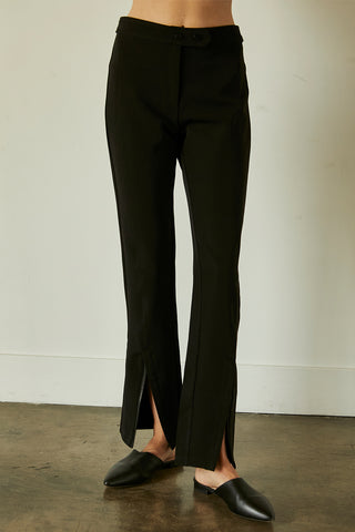 A model wearing a black front slit pants.
