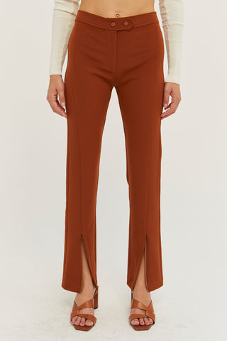 A model wearing a rust front slit pants.