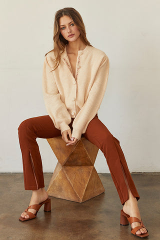 A model wearing a rust front slit pants.