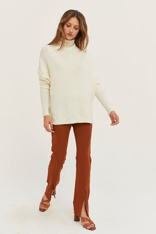 A model wearing a rust front slit pants.