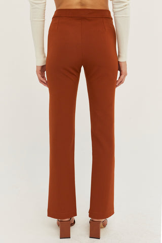 A model wearing a rust front slit pants.