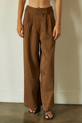 A model wearing a brown pinstripe trousers.