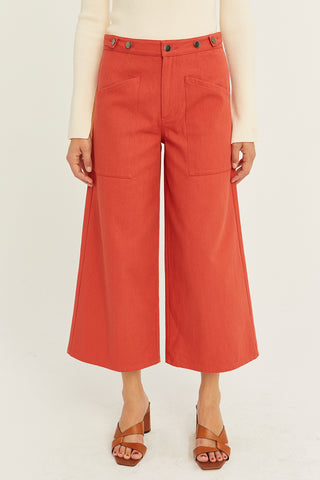 A model wearing a brick culotte pants.