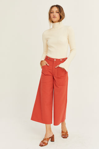 A model wearing a brick culotte pants.