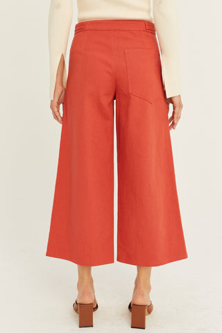 A model wearing a brick culotte pants.
